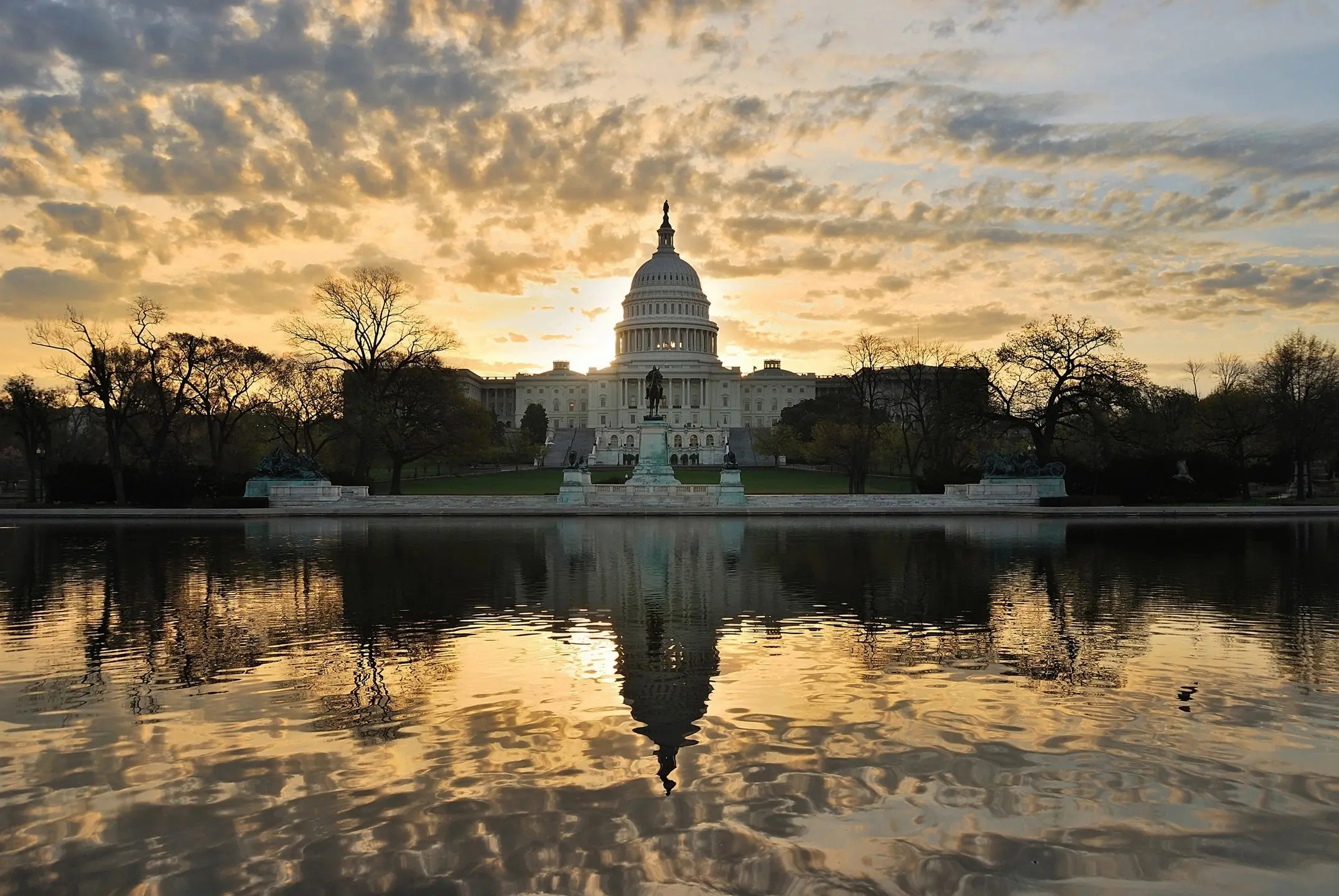 Capitol building at sunrise with reflection