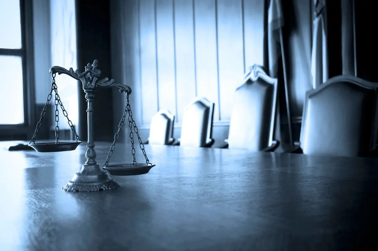 Justice balance in dimly lit room