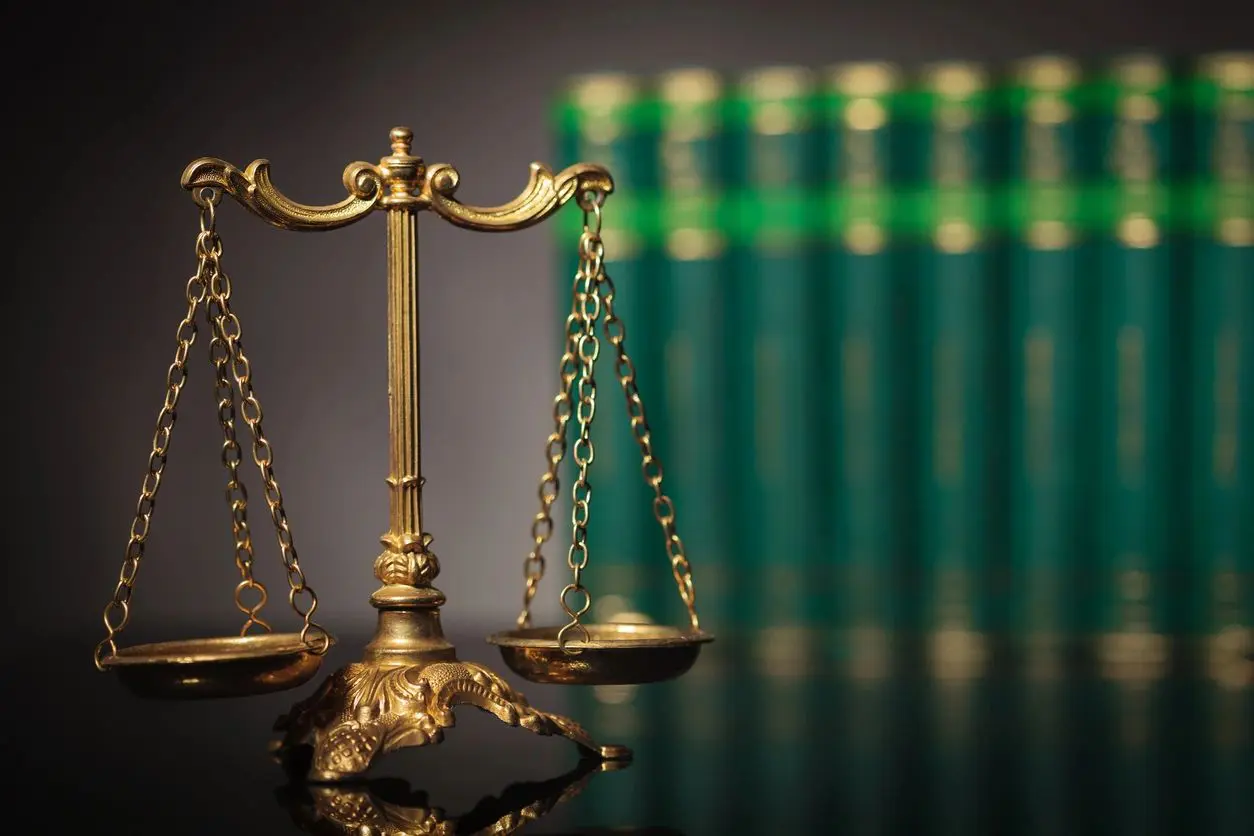 Legal scales with green books background