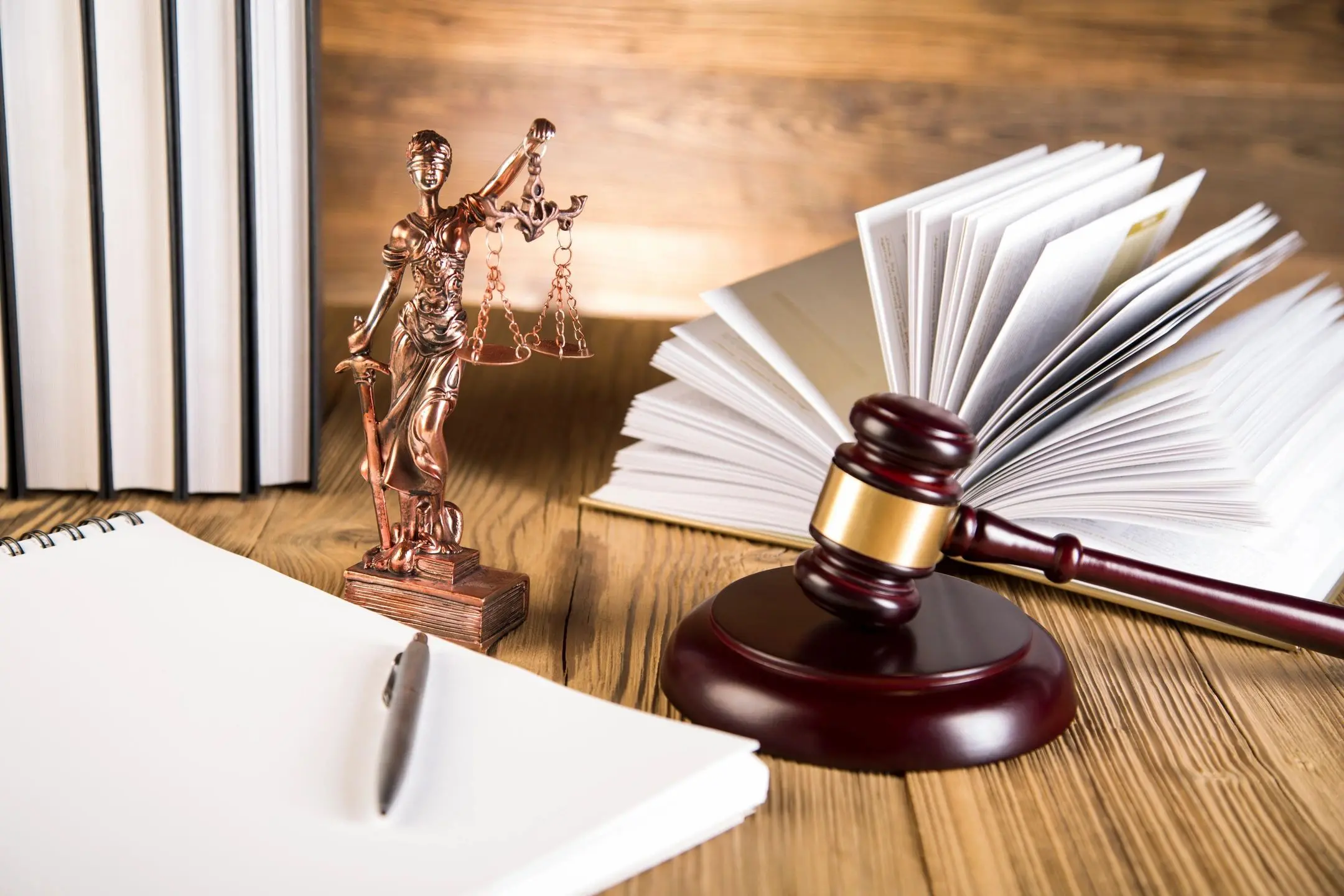 Legal symbols and open book on desk