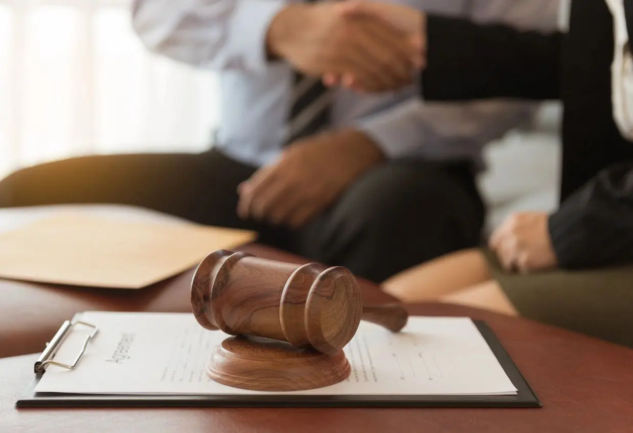 Business deal handshake and gavel