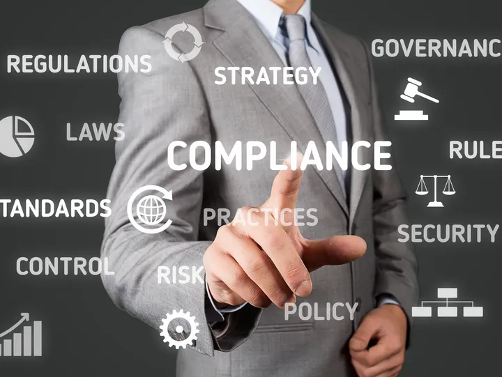Man touching compliance strategy words